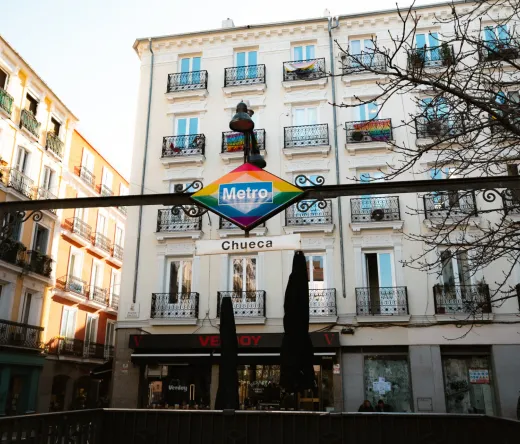 Madrid's Chueca neighborhood: A vibrant metro sign and colorful buildings.