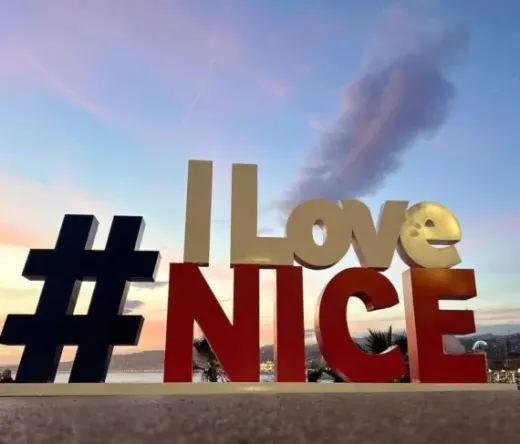 The iconic "I Love Nice" sign in Nice, France, at sunset.