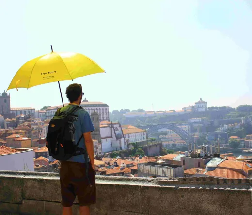 Tourist enjoying a free walking tour in Porto, Portugal.