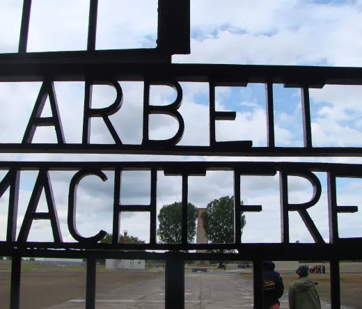 Tourists visiting the Sachsenhausen Concentration Camp gate in Berlin, Germany.