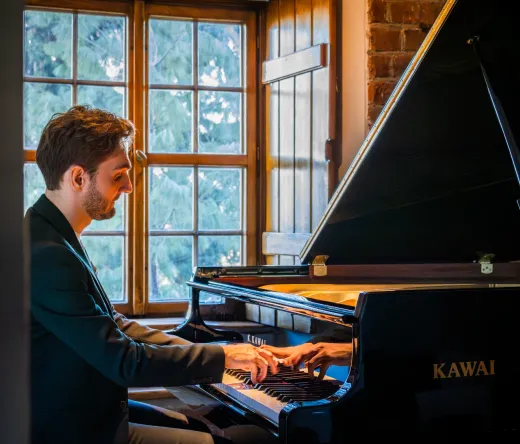 Pianist at a grand piano in a Warsaw concert hall.