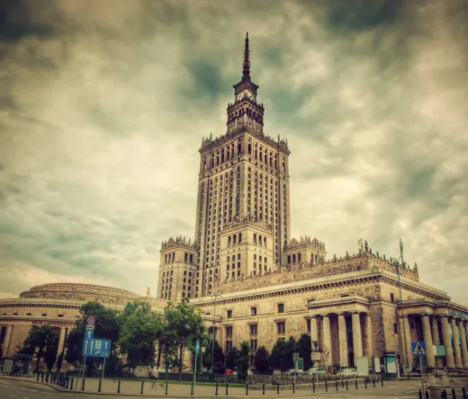 The Palace of Culture and Science in Warsaw under a dramatic sky.