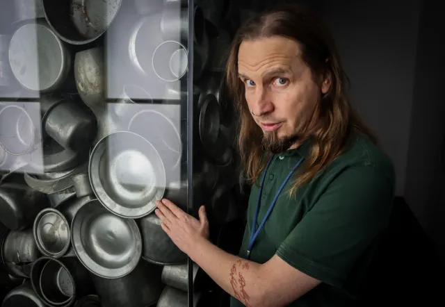 Tour group listening to guide in a museum exhibit.