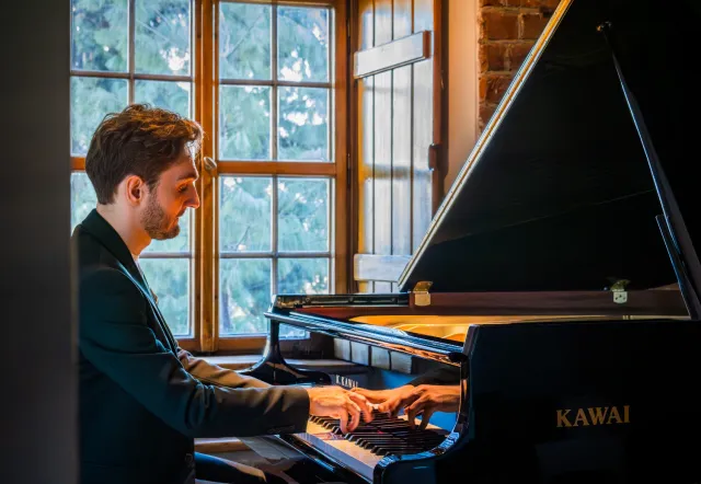 Pianist at a grand piano in a Warsaw concert hall.