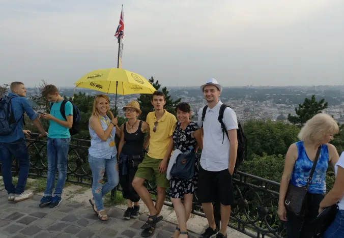 A guided walking tour group in Lviv, Ukraine, enjoying a panoramic city view.