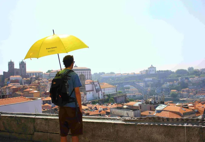 Tourist enjoying a free walking tour in Porto, Portugal.