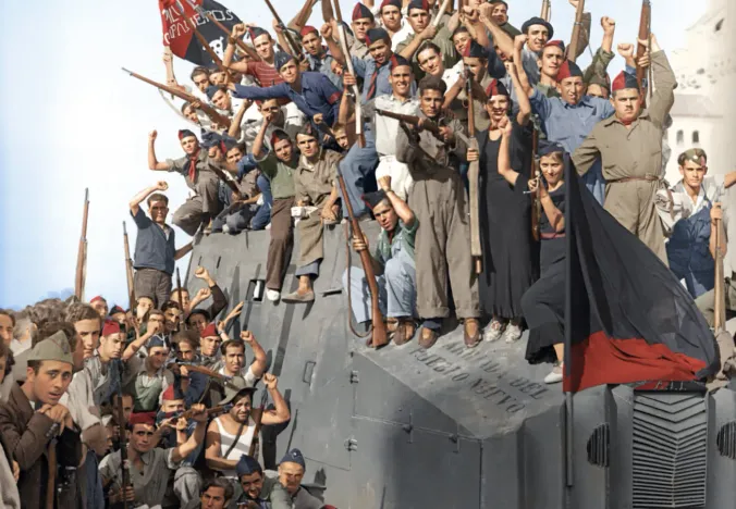 Spanish Republican soldiers celebrate atop an armored car during the Spanish Civil War.