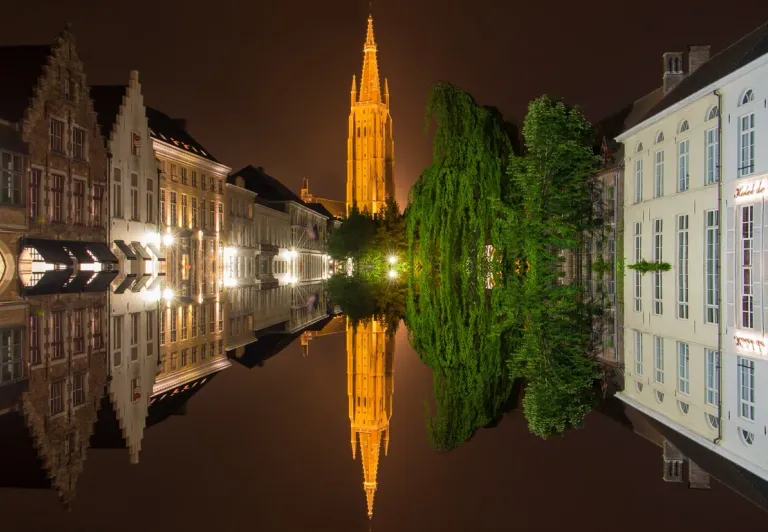 Bruges by Night: Stunning reflection of the Belfry and canals.