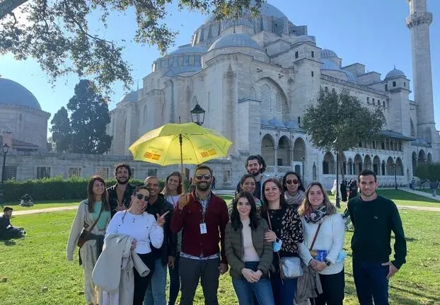 Happy tour group in front of the Süleymaniye Mosque in Istanbul.
