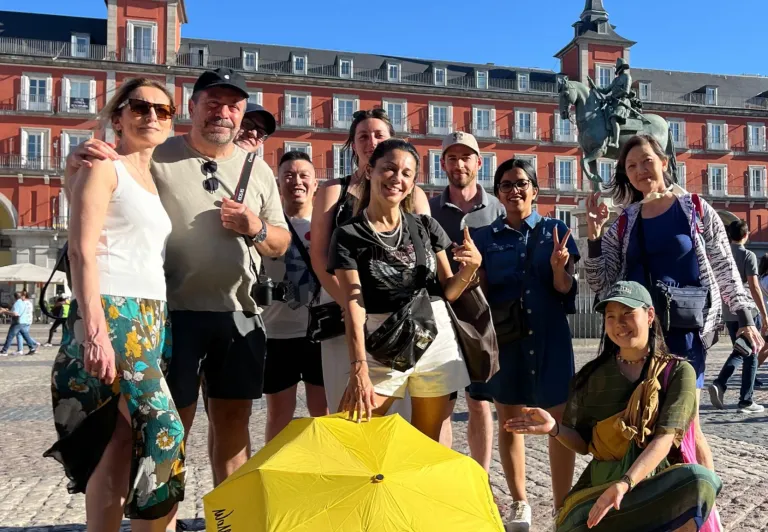 Happy tourists on a WALKATIVE! tour in Madrid's Plaza Mayor.