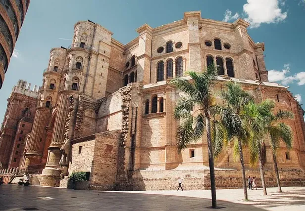 Tourists explore the magnificent Murcia Cathedral in Spain.
