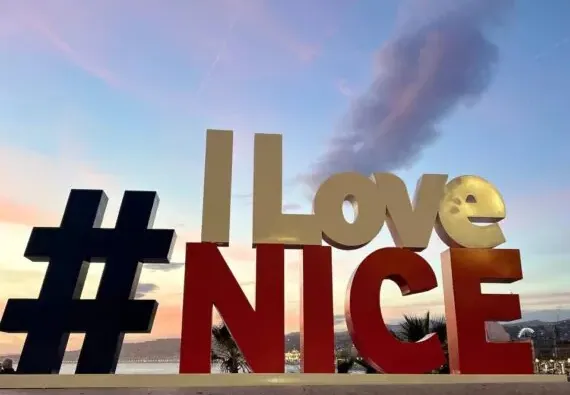 The iconic "I Love Nice" sign in Nice, France, at sunset.