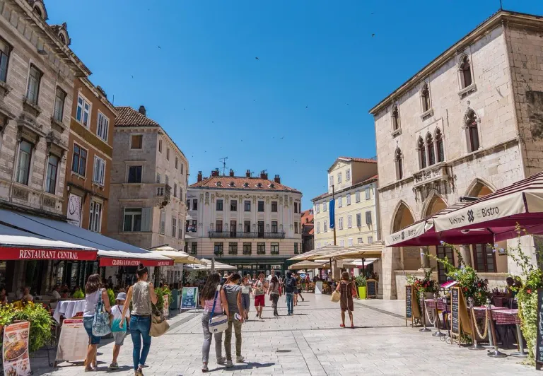 Tourists exploring a beautiful square in Split, Croatia.