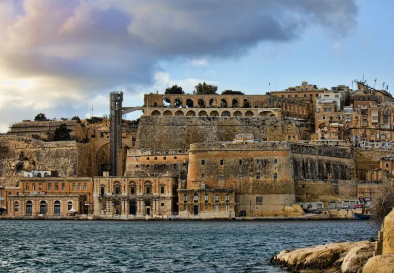 Historic Valletta waterfront in Malta, showcasing ancient fortifications and buildings.