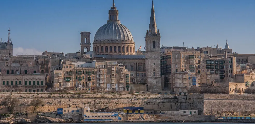 Valletta skyline from the sea, showing the dome of Our Lady of Mount Carmel Basilica, St Paul's Pro-Cathedral spire, and hist