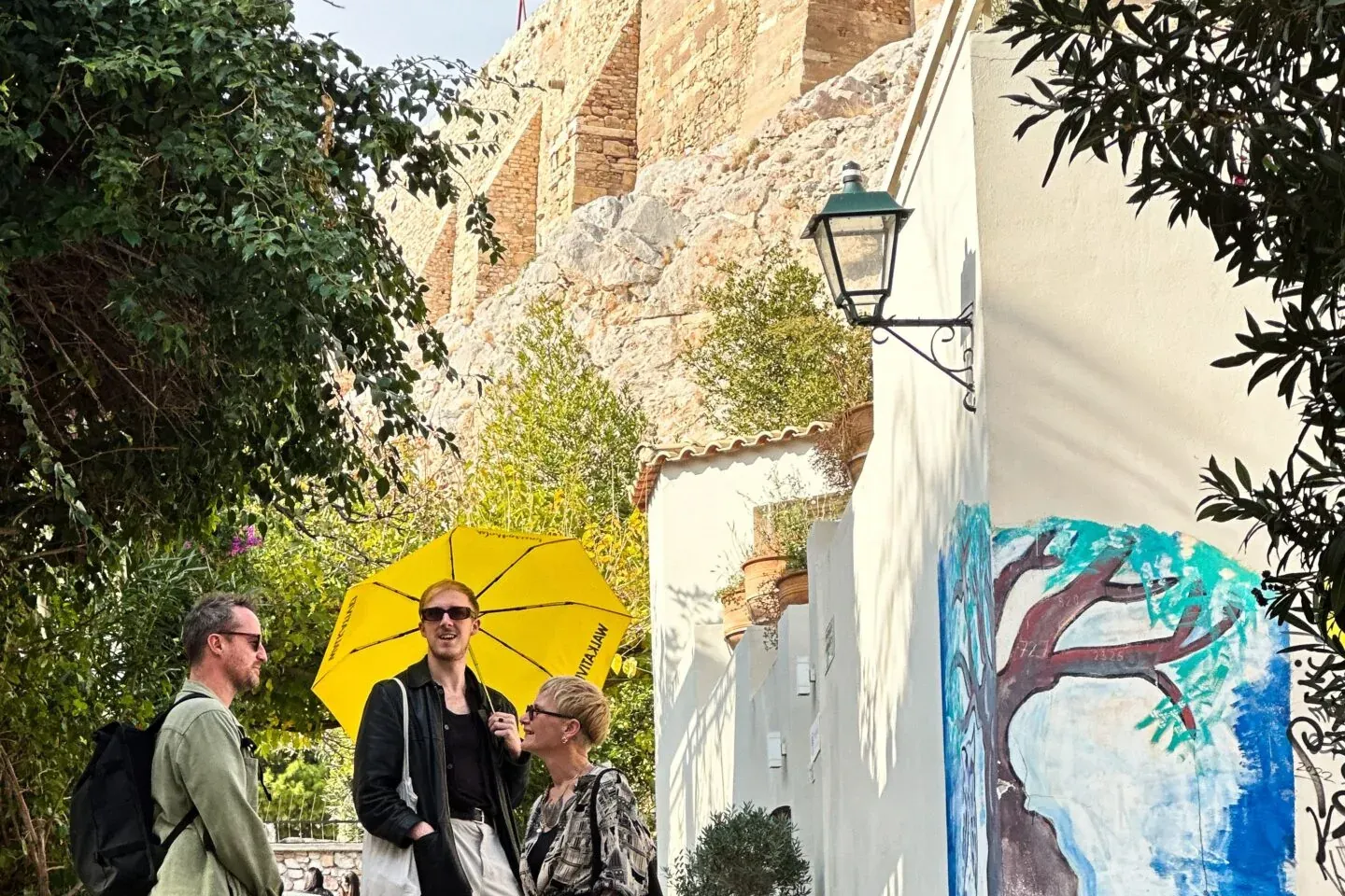 Tourists exploring Athens, Greece, near the Acropolis.