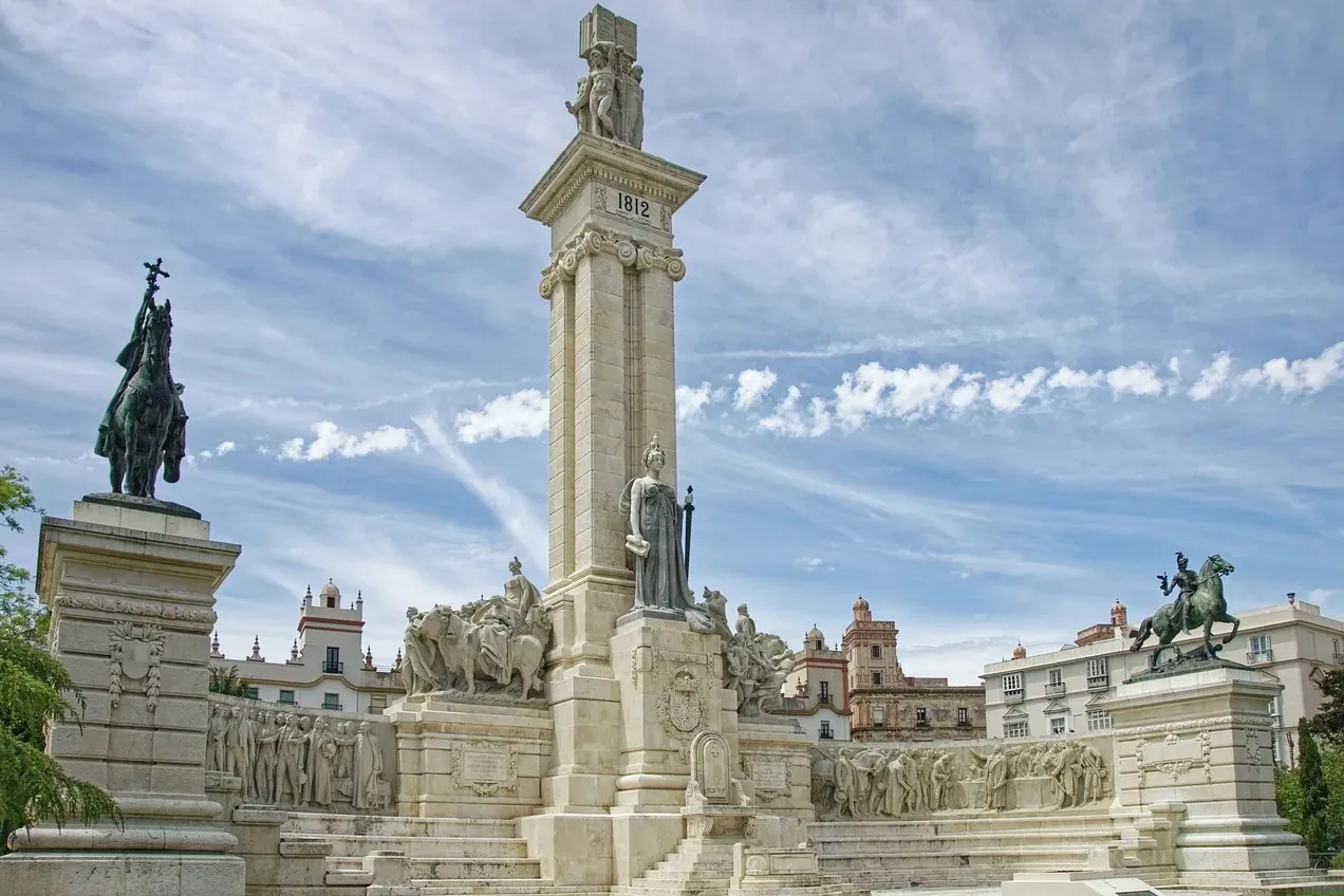 Monument to the 1812 Constitution in Cadiz, featuring a tall central column with statues, surrounded by relief panels and ...