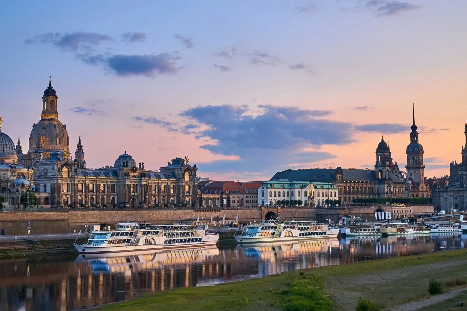 Dresden skyline at sunset, reflecting in the Elbe River.