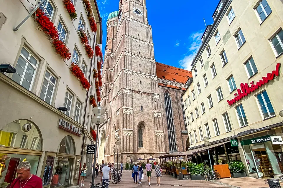 Our Lady's Cathedral in Munich, Germany, dominates a charming street scene.