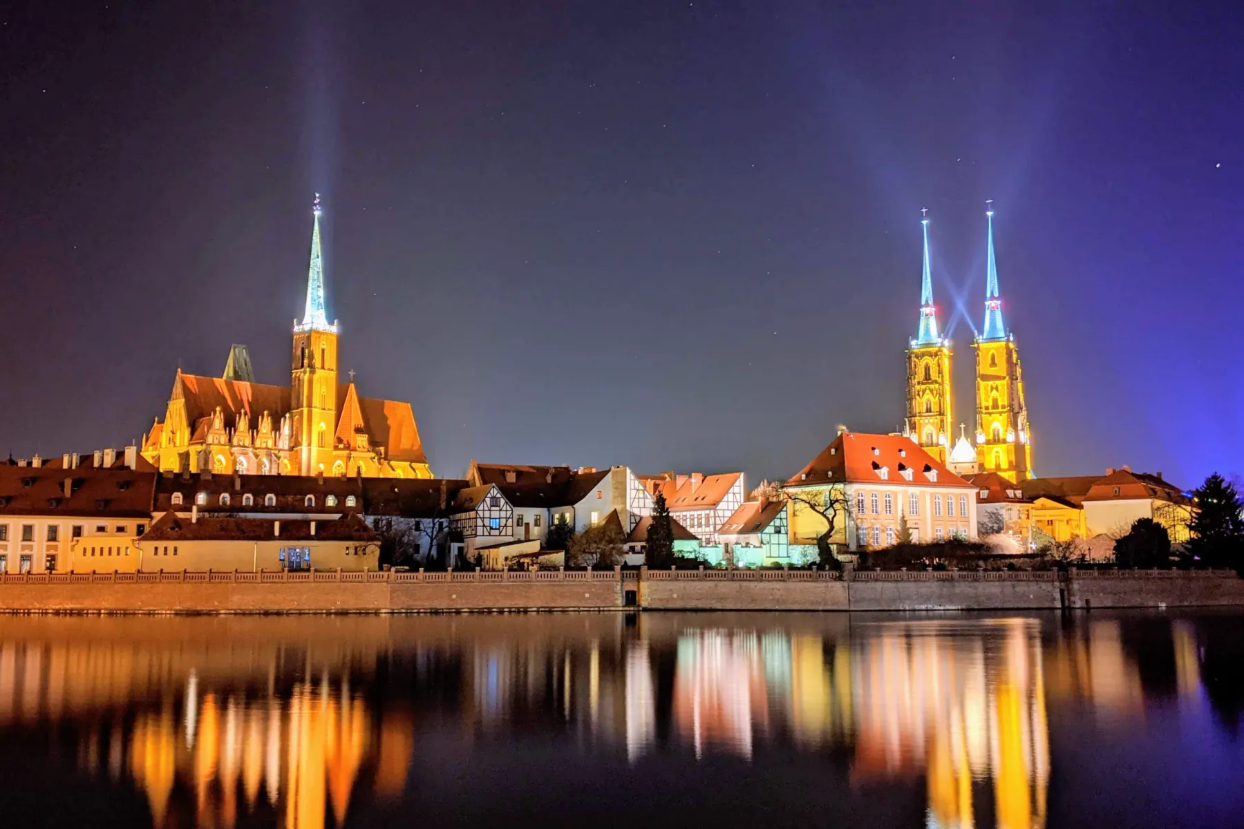 Night view of Wroclaw's Cathedral Island, reflecting in the Oder River.