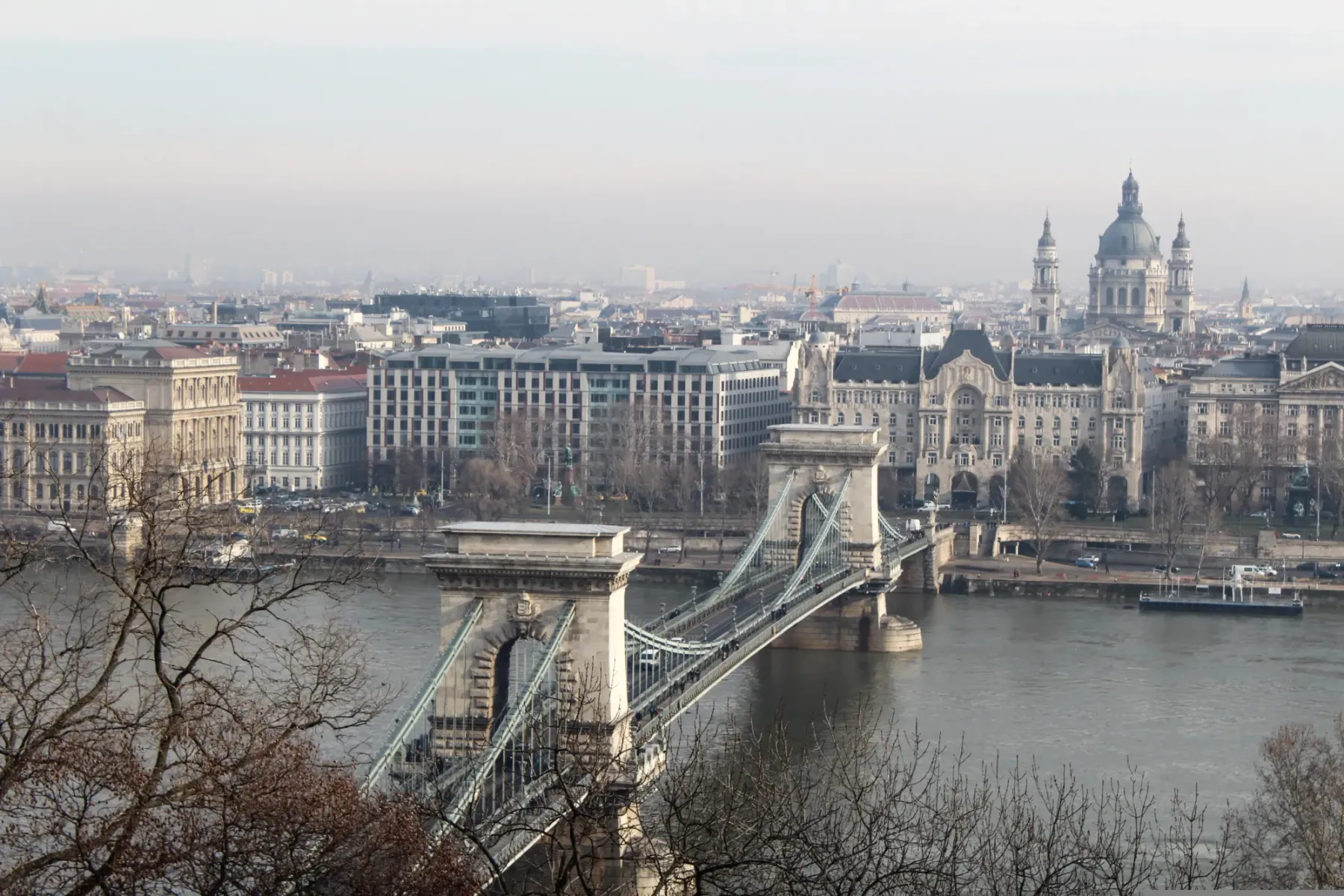 View over the Szechenyi Chain Bridge and the Danube River towards the Pest side of Budapest on a hazy day.