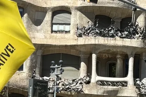 Antoni Gaudí's La Pedrera (Casa Milà) in Barcelona, with its wavy stone facade, iron balconies, and unique rooftop element...