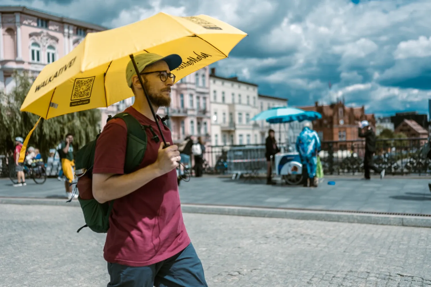 A Walkative guide with the characteristic yellow umbrella.