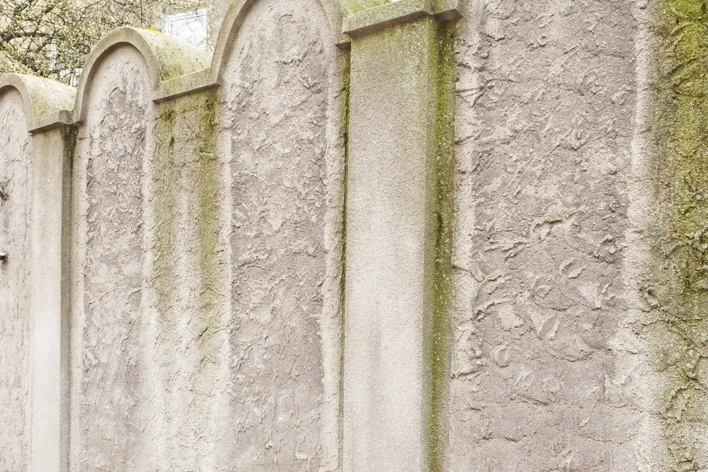 A section of the Krakow Ghetto wall memorial, whose arched top resembles a Jewish tombstone (matzevah).