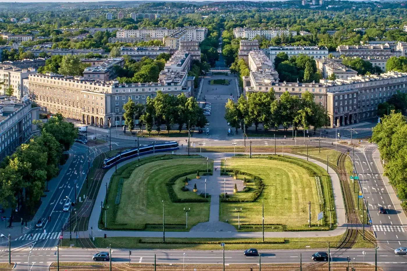 Aerial view of Plac Centralny in Nowa Huta, Krakow, showing its symmetrical layout, buildings, and green spaces on a sunny...