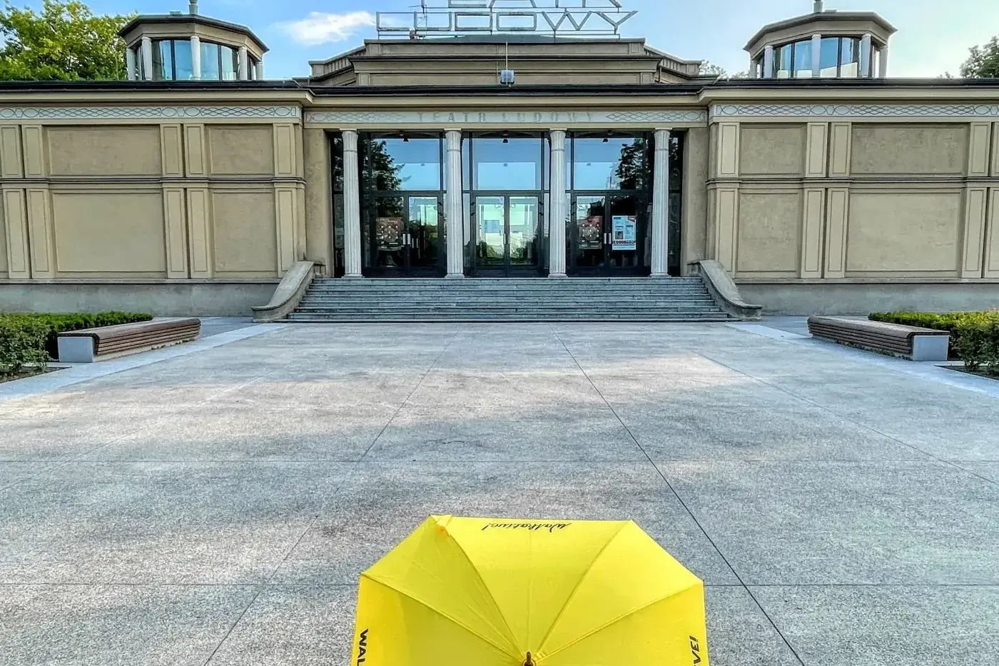 A yellow Walkative umbrella on the plaza in front of the Teatr Ludowy (People's Theatre) in Krakow's Nowa Huta district.