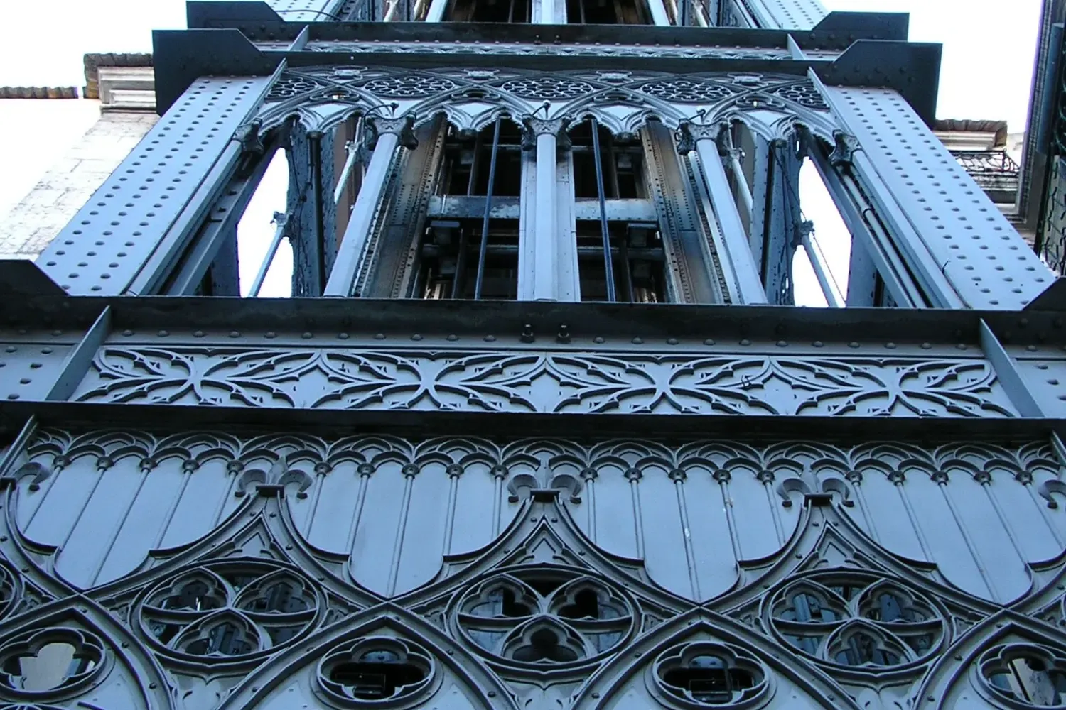 Looking up at the ornate neo-Gothic ironwork of the Santa Justa Lift in Lisbon.