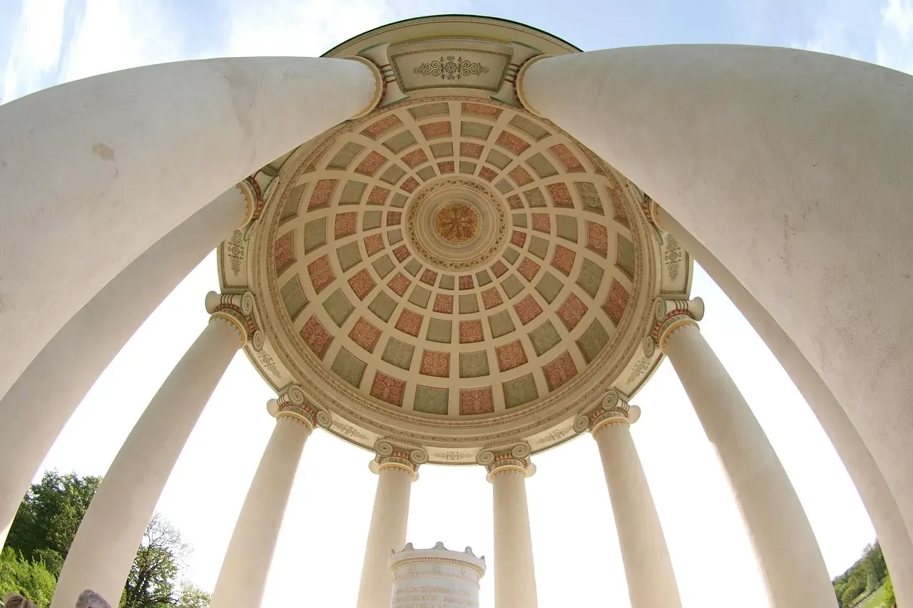 Interior view of the Monopteros rotunda in Munich's Englischer Garten, showing its classical dome ceiling with ornate patt...