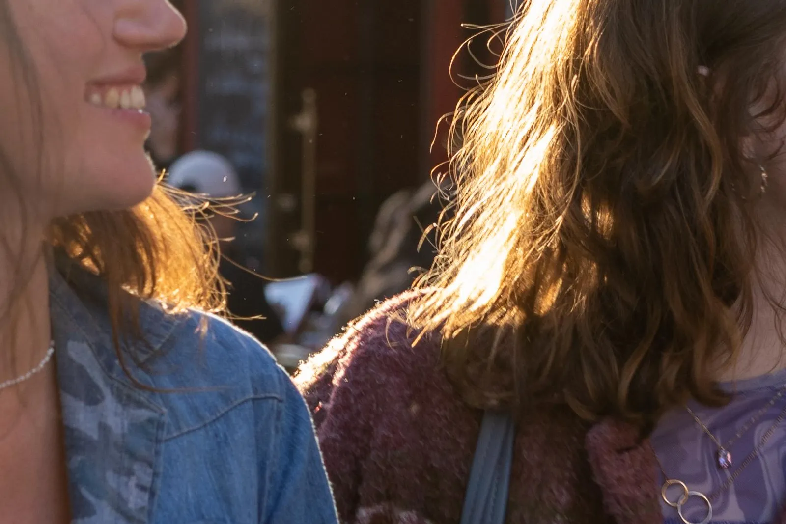 Two people with sunlit hair in front of La Mère Catherine restaurant in Montmartre, Paris.
