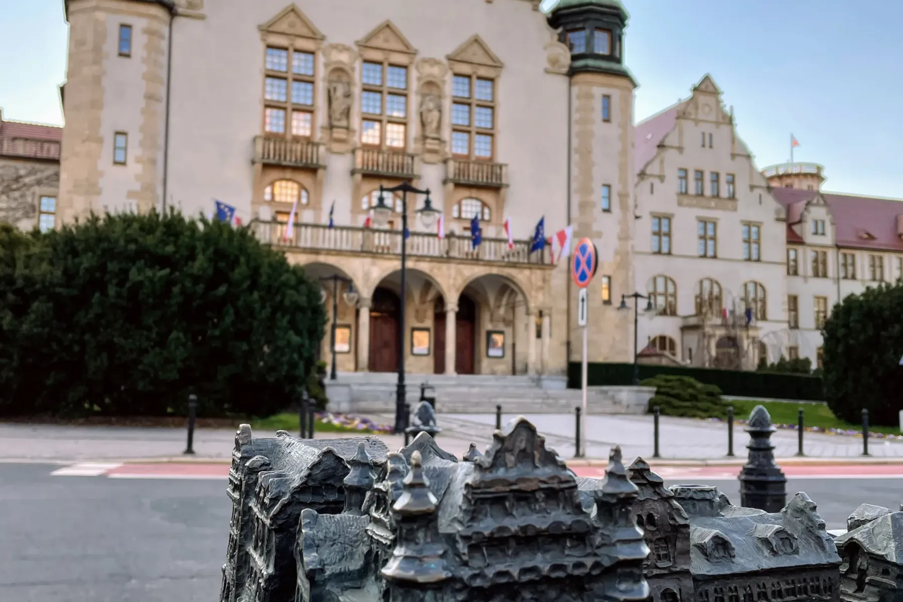 Bronze architectural model of old town buildings in the foreground, with the grand Collegium Minus of Adam Mickiewicz Univ...