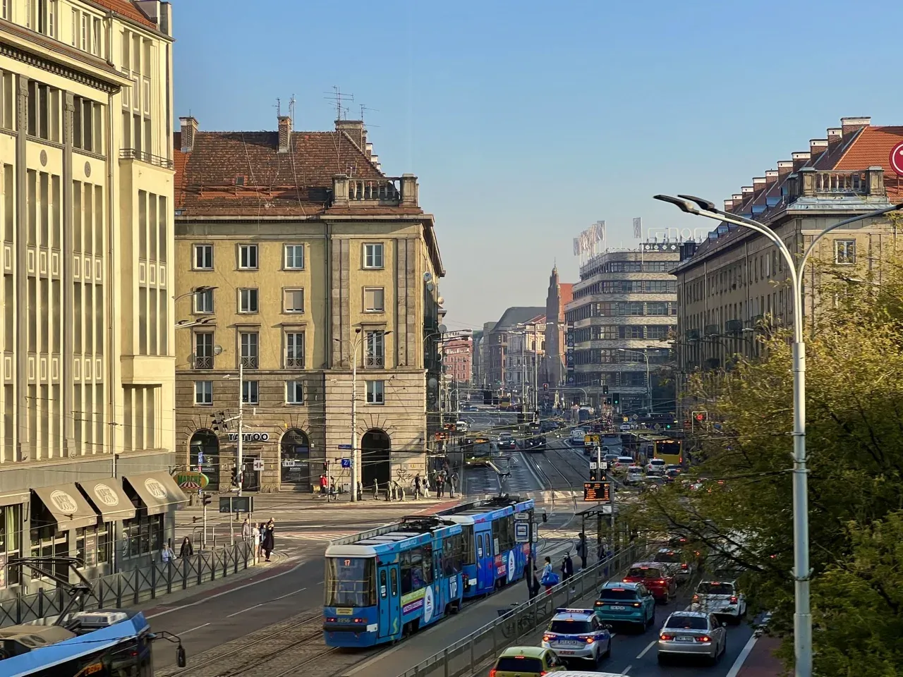 A bustling street scene in Wroclaw, Poland, featuring a tram and historic architecture.