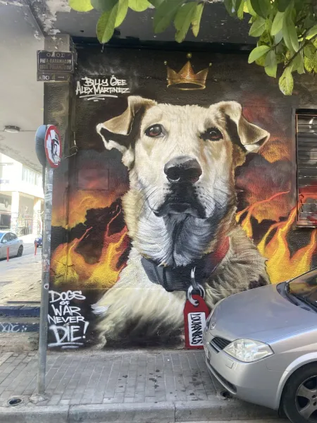 Street art mural in Athens, Greece, featuring a dog with a crown.