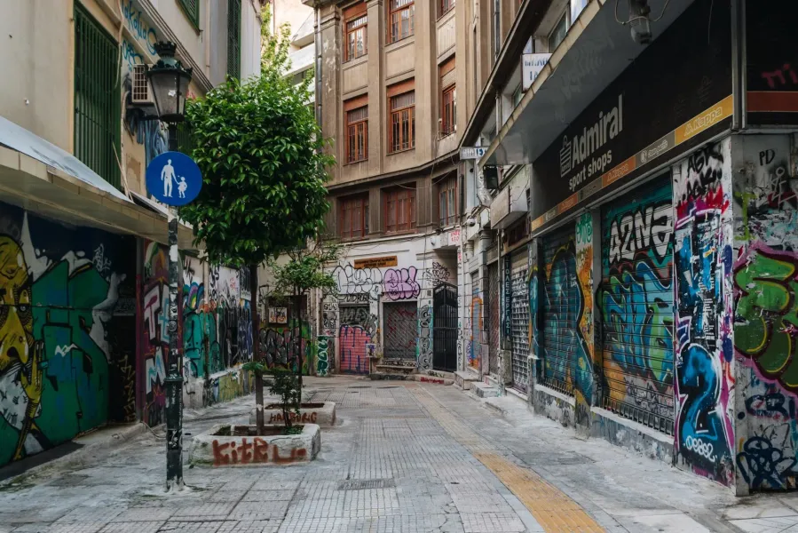 Colorful graffiti art adorns the walls of a narrow alleyway in Athens, Greece.