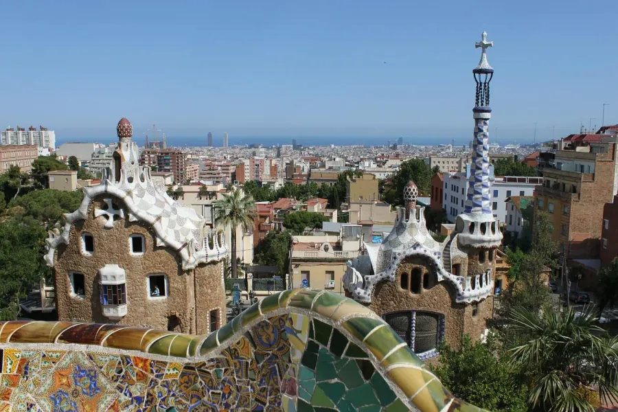 Panoramic view of Barcelona from Park Güell, showcasing Gaudí's iconic mosaic structures.