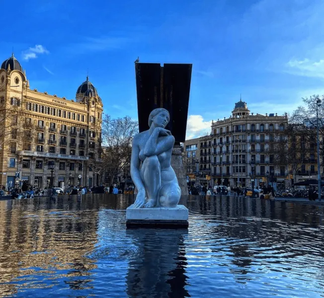 Serene statue in a Barcelona fountain.