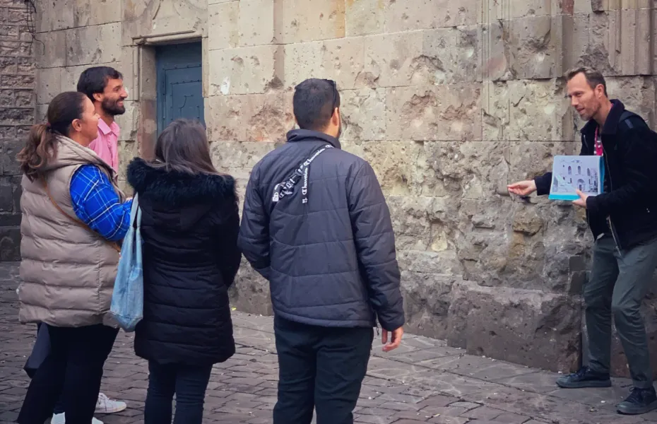 A tour guide leads a small group on a walking tour in Barcelona, Spain.