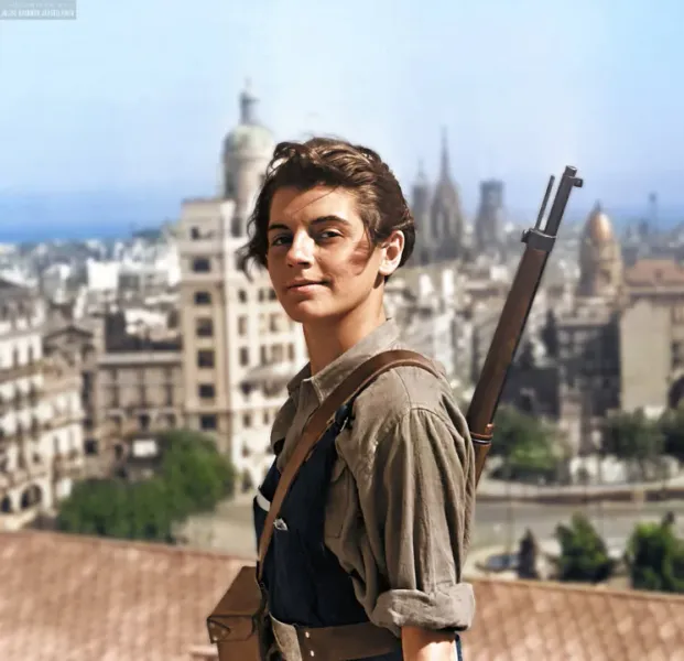 A woman in historical attire stands against the backdrop of Barcelona's cityscape.