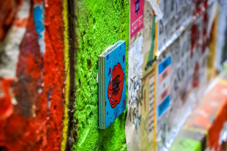 Vibrant street art in Berlin: a close-up of a painted wooden artwork.