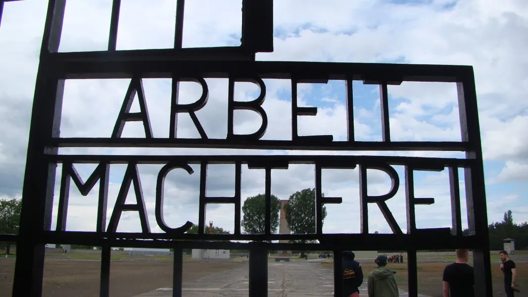 Tourists visiting the Sachsenhausen Concentration Camp gate in Berlin, Germany.