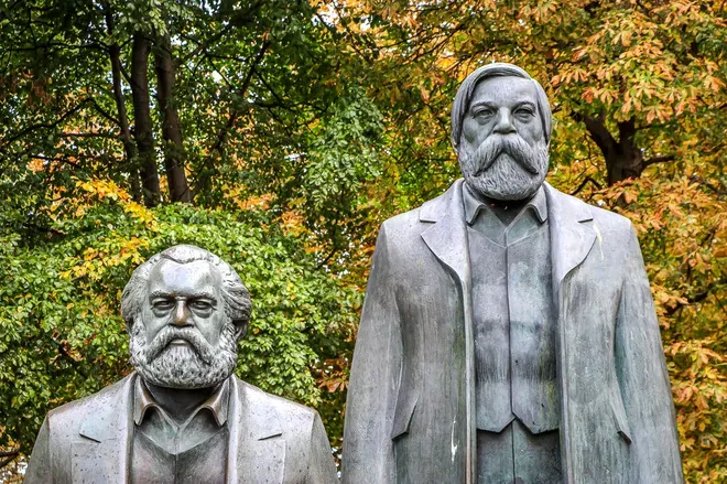 Bronze statues of Karl Marx and Friedrich Engels in a Berlin park.