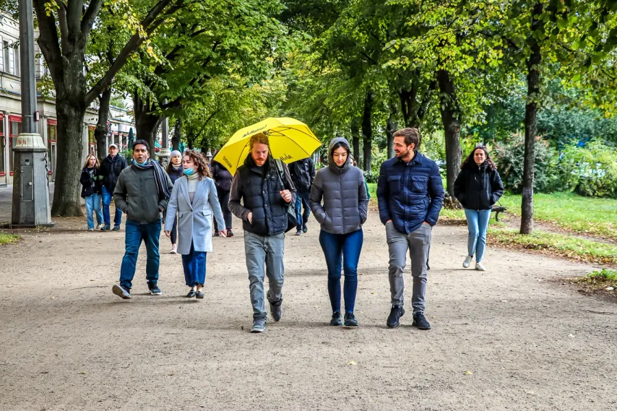 A guided walking tour group in a Berlin park.