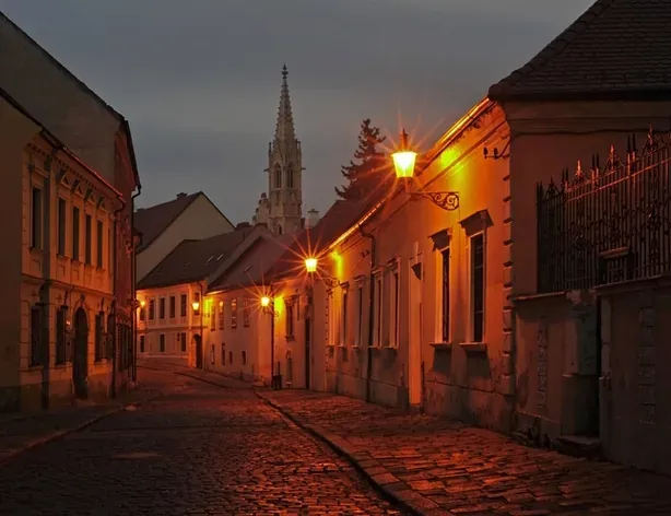 Spooky Bratislava tour: A charming cobblestone street at night.