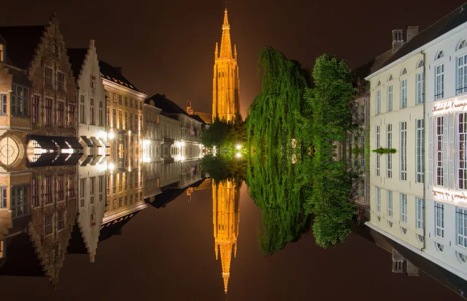 Bruges by Night: Stunning reflection of the Belfry and canals.