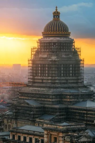 The Palace of Justice in Brussels at sunset, undergoing renovations.