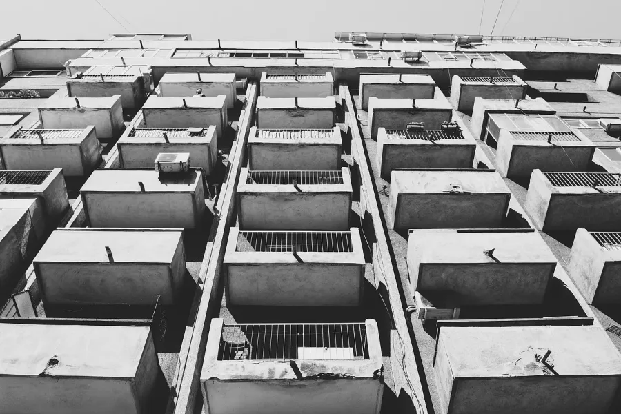 Black and white photo of a Bucharest apartment building, showcasing its unique architecture.