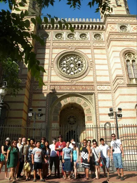 A tour group poses in front of the stunning Dohány Street Synagogue in Budapest.